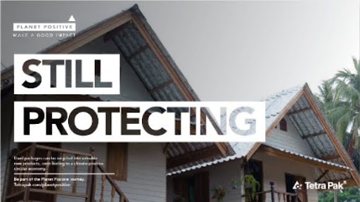 Planet Positive campaign visual reading 'Still protecting' over houses roofed with recycled carton material